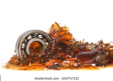 Closed up macro, ball bearing put into yellow transparent lithium grease isolated on white background with copy space, engineering and industrial concept - Shutterstock ID 1619717152