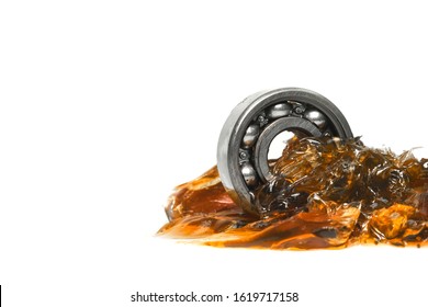 Closed up macro, ball bearing put into yellow transparent lithium grease isolated on white background with copy space, engineering and industrial concept - Shutterstock ID 1619717158