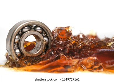 Closed up macro, ball bearing put into yellow transparent lithium grease isolated on white background with copy space, engineering and industrial concept - Shutterstock ID 1619717161