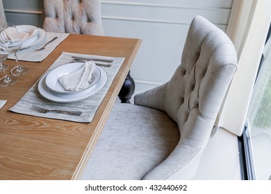 closed up nice dining chair with wooden table and dish sets interior design