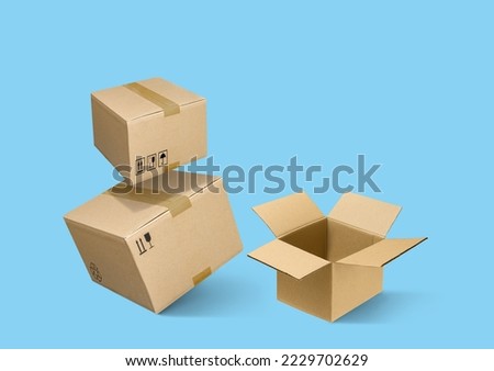 Closed and opened cardboard boxes isolated on turquoise blue background