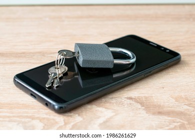 closed padlock with keys based on the concept of smartphone data protection. High quality photo