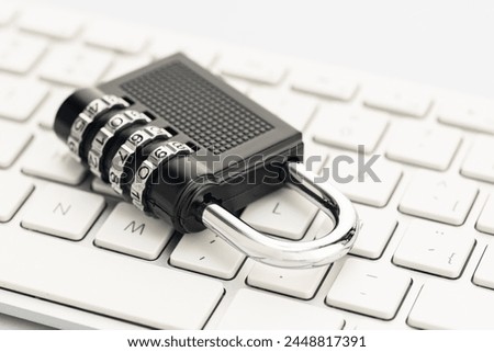Closed padlock on computer keyboard. Cyber security concept