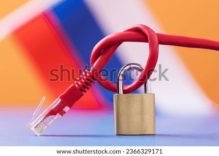 Closed padlock on a knotted network wire on the background of the Russian flag, the concept of blocking Internet resources in Russia