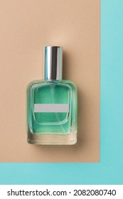 A Closed Perfume Bottle On A Blue And Beige Background. The Concept Of Natural Cosmetics. Flat Lay.