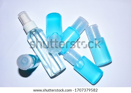 Closed up picture of alchohol gel spray plastic bottles with white background, useful for cleaning.