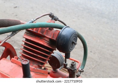 Closed Up Picture Of An Orange Air Compressor Machine With Copy Space.