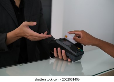 Closed up with reception and customer swipe credit card for payment at the counter, Business and finance concept.