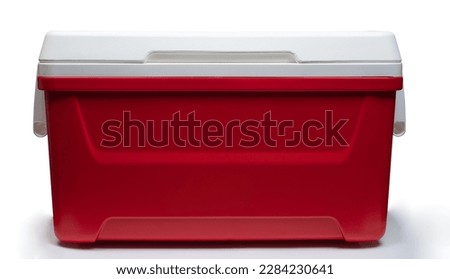Closed red  plastic thermo refrigerator  front view isolated on white studio background