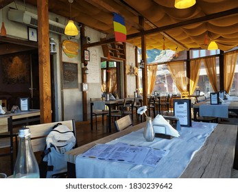 Closed Restaurant With Empty Tables, Without Customers. Restaurant Interior. Cozy Wooden Interior Of Restaurant. Bran, Romania, October 9, 2020