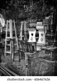 Closed shop window with clutter stacked inside 