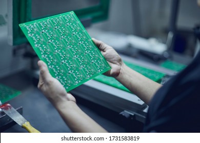 Closed Shot Of Female Electronics Factory Worker Holding Printed Circuit Board. Laboratory Of Electrical Design.