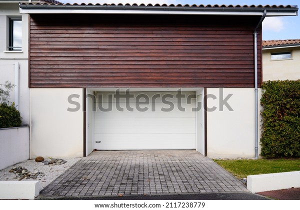 closed shutter door roller white metal\
garage gate in home facade wall street\
entrance