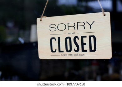 Closed sign door. Text on a wood sign "sorry we are closed please come back again". A closed sign on a wood plate - Shutterstock ID 1837707658