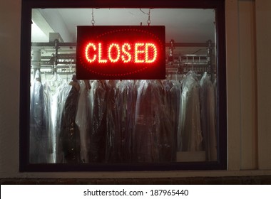 Closed Sign In Dry Cleaners Window