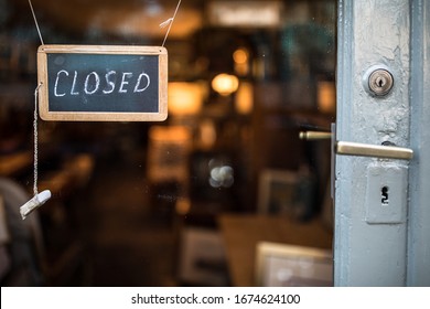 Closed - Sign Hanging On Glass Door Of A Shop In A City