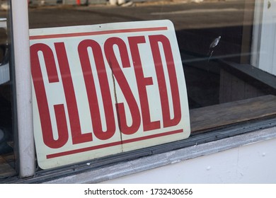 A closed sign in a store front window due to the COVID-19 Pandemic