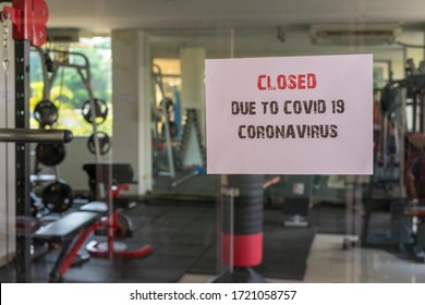 Closed Sign With The Words Due To Covid 19 Coronavirus On A Glass Window In Gym Due To Covid-19 Or Corona Virus Outbreak Pandemic Crisis. 