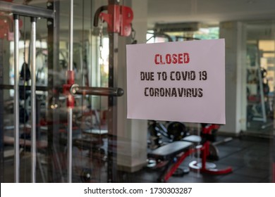 Closed Sign With The Words Due To Covid 19 Coronavirus On A Glass Window In Gym Due To Covid-19 Or Corona Virus Outbreak Pandemic Crisis. 