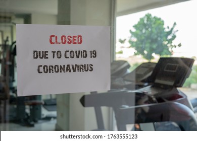 Closed sign with the words closed due to covid 19 coronavirus on a glass window in gym due to Covid-19 or Corona virus outbreak pandemic crisis.  - Powered by Shutterstock