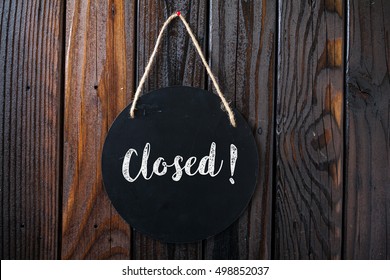 Closed Sign Written In Chalk On Chalkboard On Rustic Vintage Wood Background. Top View Selective Focus.