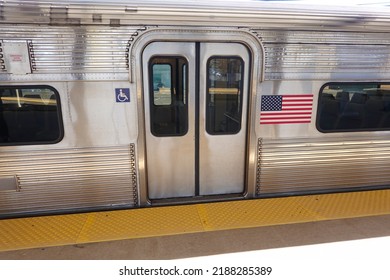 Closed Sliding Doors Of A Silver Subway Train Car Stopped At An Outdoor Station