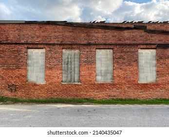 a closed small town factory warehouse abandoned building red brick wall empty desolate disaster area