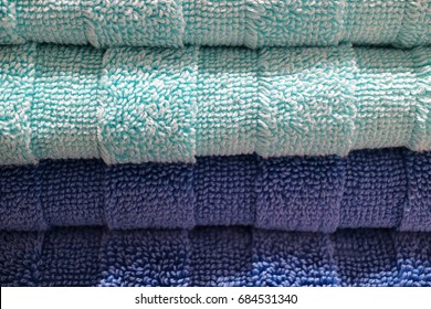 Closed up stack of deep blue and pale blue fluffy bath towels, for texture and background 