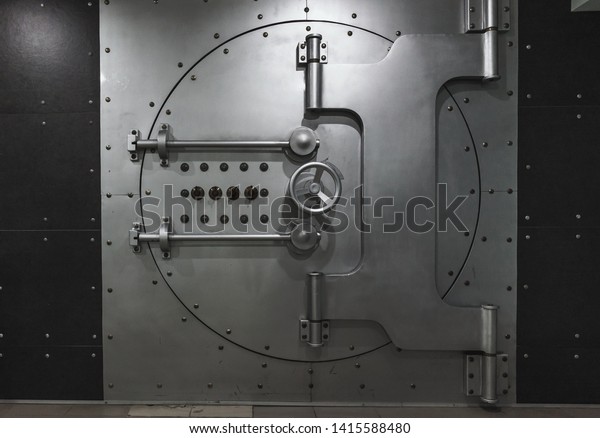 Closed steel bank vault door, close-up. Bank\
vault. Safe storage of\
valuables