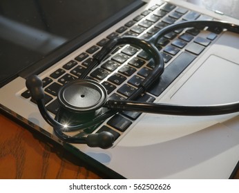 Closed Up Stethoscope On Laptop With Warm Light On Doctor Table