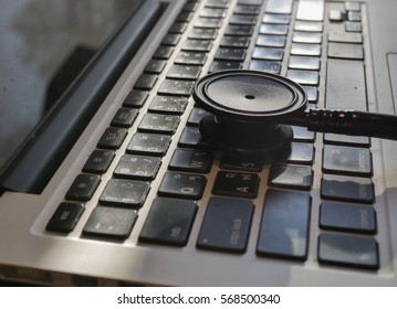 Closed Up Stethoscope On Laptop With Warm Light On Doctor Table