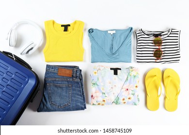 Closed Suitcase Fully Packed With Folded Women Clothing And Accessories On The Floor. Woman Packing For Tropical Vacation Concept. Female Luggage W/ Things. Background, Close Up, Copy Space, Top View