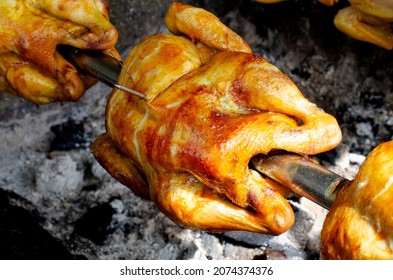 Closed up Thai style grilled chicken cooking in street food market in Bangkok, Thailand