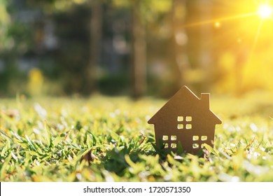 Closed up tiny home model on green grass with sunlight background. - Powered by Shutterstock