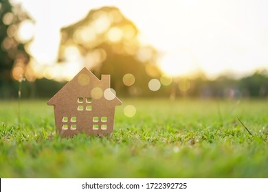 Closed up tiny home model on green grass with sunlight background. - Powered by Shutterstock