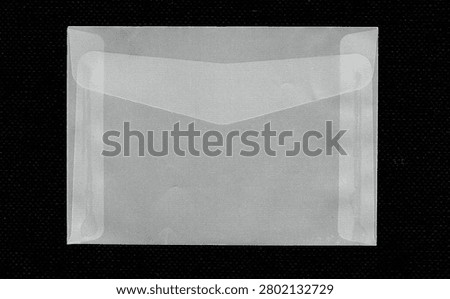 Closed translucent vellum envelope isolated on black background