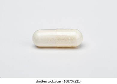 closed up of a transparent pill filled with white ingredient - Shutterstock ID 1887372214