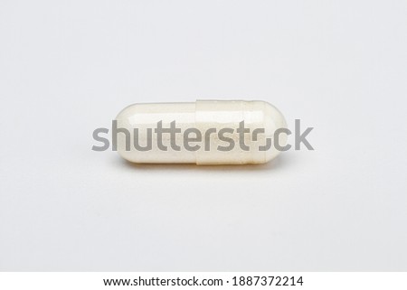 closed up of a transparent pill filled with white ingredient