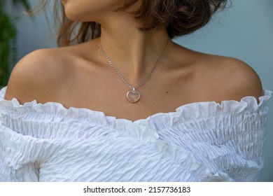 Closed Up Of Trendy Woman Outfit Wearing White Shirt And Heart Shape Necklace. Fashion Concept. Valentine Day