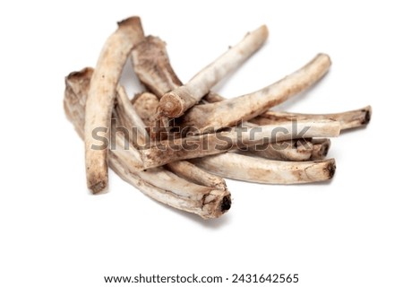 Closed view of a pile of bones after dinner with leftover meat.