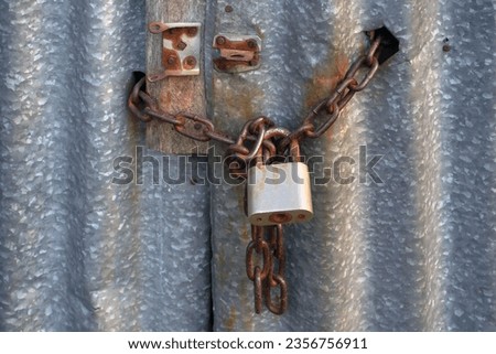 closed warehouse secured with steel chain and padlock