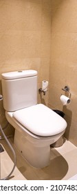 A Closed White Ceramic Toilet Bowl In A Clean Modern Washroom.