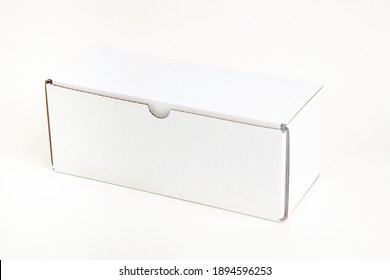 A Closed White Rectangular Cardboard Packaging Box Set On Plain White Background.