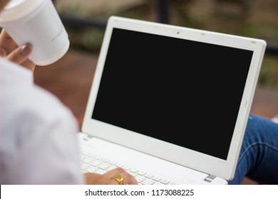 Closed Up White Shirt Woman Are Drinking A Coffee Paper Cup, Seeing And Typing Key Board On Laptop With Any About Online Transaction. No Matter If It's Shopping, Banking, Emailing Or Bussiness Contact