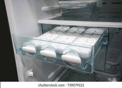 Closed Up White Side By Side Ice Maker And Ice Tray In New Open Freezer.