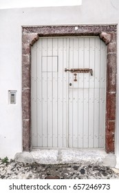 Closed White Slat Door With Speakeasy Opening And Rivets