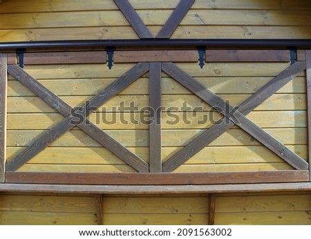 closed wooden light shutters with dark crosshairs of shopping market stall in rustic style, peasant design in urban architecture, wooden shopping tent with closed shutters as rustic texture background