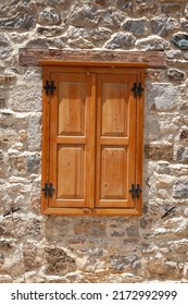 Closed Wooden Windows And Shutters In The Stonewall. Wooden Windows In An Old Stonewall 