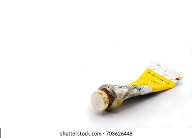 closed-up dried yellow squeezed used oil color tube for painting on a white background. original unique oil tube. painting equipment - Powered by Shutterstock