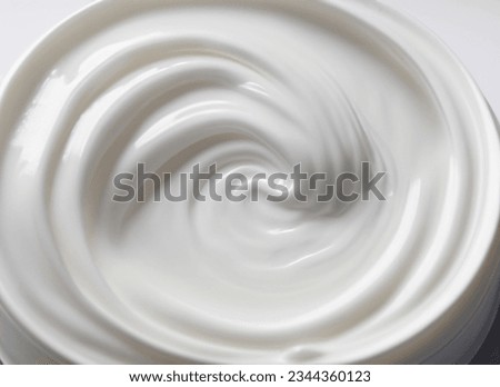 A Closed-Up Shot of Swirling White Facial Cream